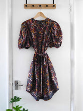 Load image into Gallery viewer, Anthea Dress with tie belt made with Hilma Rust EcoVero fabric displayed on hanger

