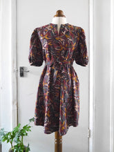 Load image into Gallery viewer, Anthea Dress made with Hilma Rust EcoVero fabric, displayed on mannequin with tie waist belt

