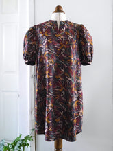Load image into Gallery viewer, Anthea Dress made with Hilma Rust EcoVero fabric, displayed on mannequin hangs loose
