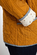 Load image into Gallery viewer, Close up of hand in pocket, showing cuff turn up detail in contrasting fabric
