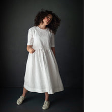 Load image into Gallery viewer, Lady wears the Ellis &amp; Hattie Dress, with elbow length sleeves
