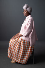 Load image into Gallery viewer, Lady sits wearing a Ellsworth top in check fabric
