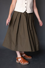 Load image into Gallery viewer, Front view of pleated Shepherd Skirt worn with sandals
