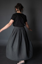 Load image into Gallery viewer, Back view of lady wearing Shepherd Skirt as she twirls around
