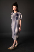 Load image into Gallery viewer, Lady wears a long tee-shirt dress with chest patch pocket in a check pattern
