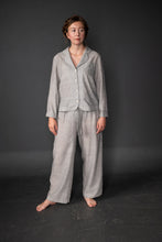 Load image into Gallery viewer, Lady stands wearing long sleeved pyjama top and long trouser set
