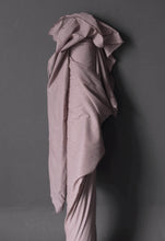 Load image into Gallery viewer, Fabric roll stood against a wall with Organic Cotton Voile fabric draped over itself
