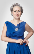 Load image into Gallery viewer, Close up view of top of the cowl neckline folded and draped down, held by a floral brooch.
