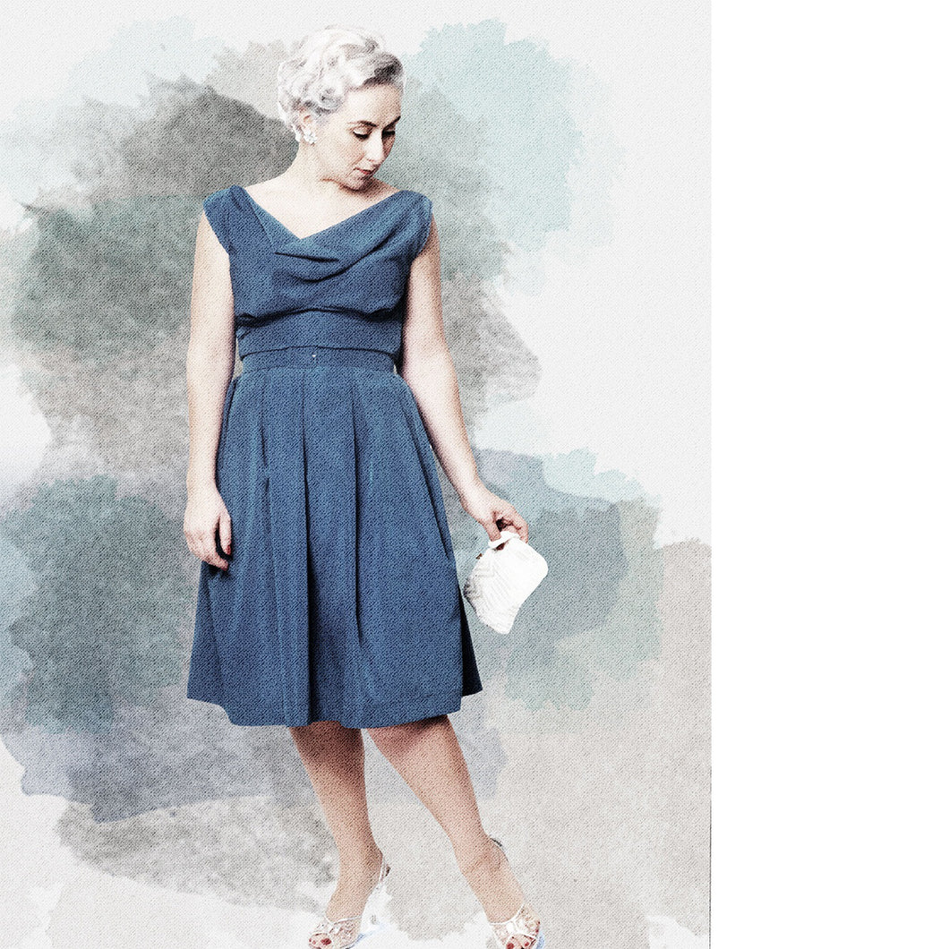 Illustration effect of lady wearing the No 1 Dragør dress. Cowl neckline, pleated waist, knee length dress.