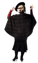 Load image into Gallery viewer, Back view of lady wearing cape made from big check/plaid fabric. Arms raised emphasising low hip length of cape. 
