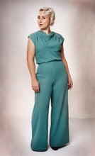 Load image into Gallery viewer, Full length view of lady wearing green Vanlose trouser suit.
