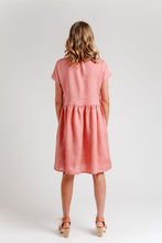 Load image into Gallery viewer, Back view of lady wearing a knee-length dress, with short sleeves, gathered seam at the waist
