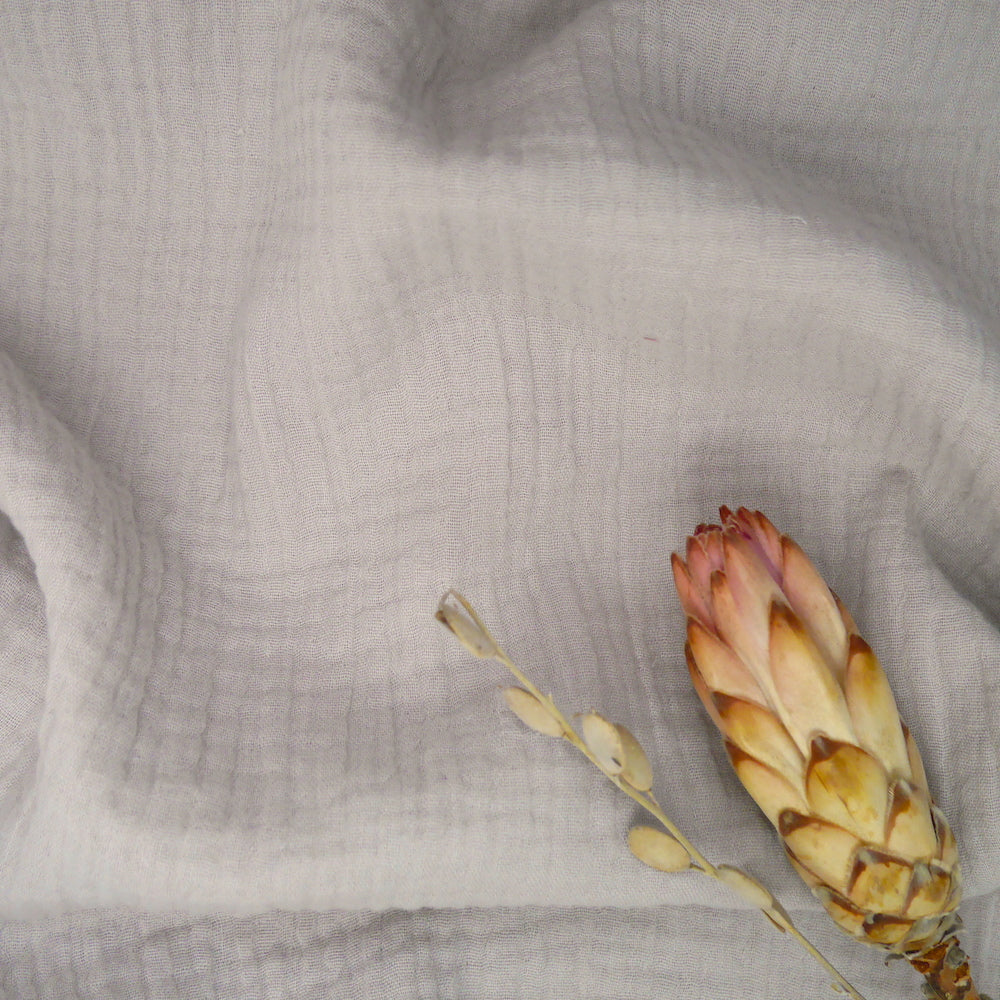 Organic Cotton Double Gauze fabric slight crumpled with dried flowers laid on top