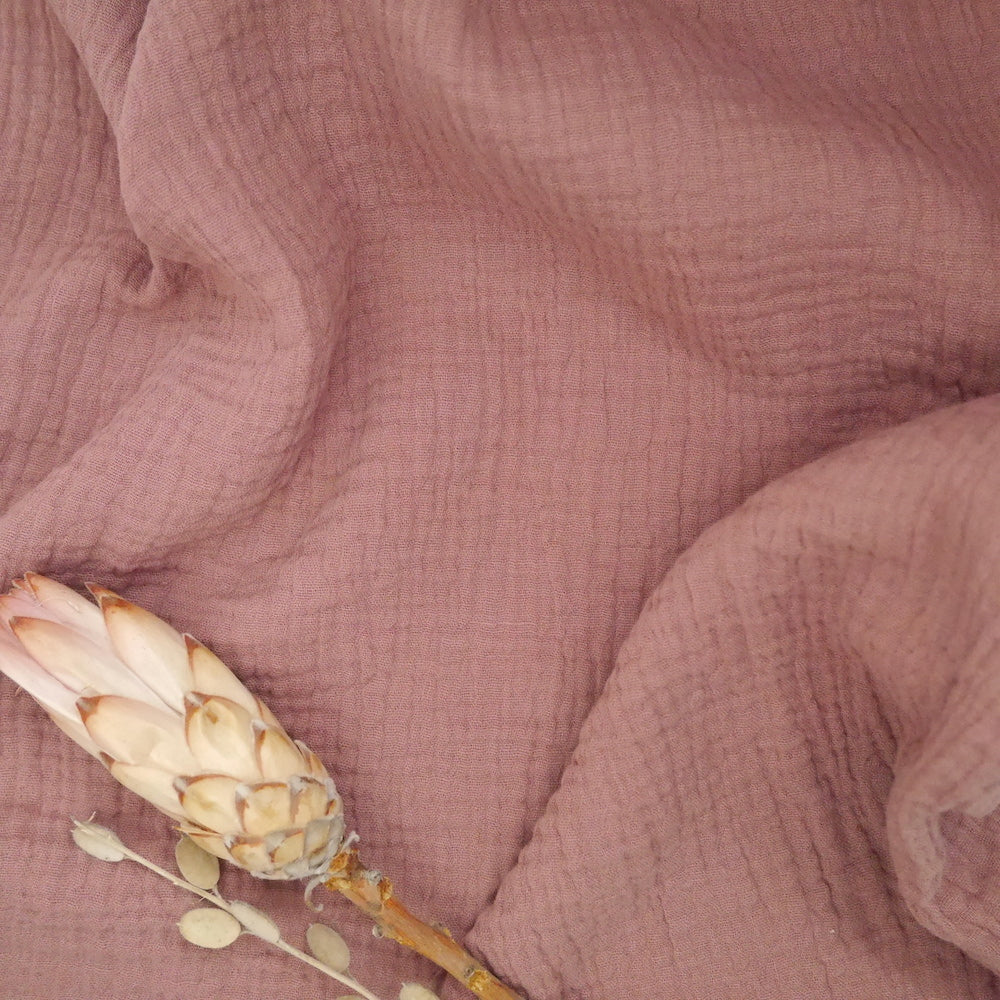 Organic Cotton Double Gauze fabric slightly crumpled with dried flowers laid on top