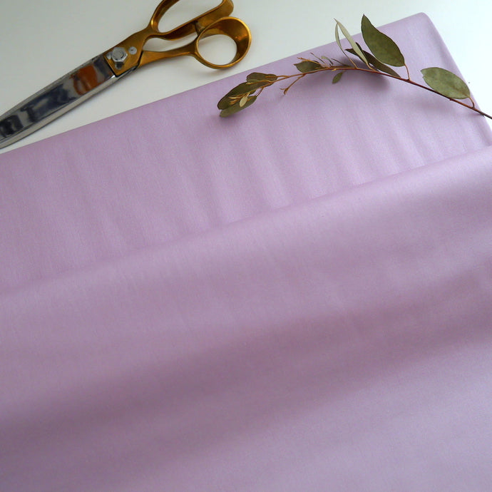 Bolt of Organic Cotton Poplin fabric in solid colour rolled out