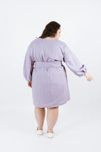 Load image into Gallery viewer, Back view of lady wearing thigh length dress with tie waist belt and puffy bell sleeves
