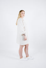 Load image into Gallery viewer, Side view of lady wearing thigh length straight cut dress and puffy bell sleeves
