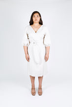 Load image into Gallery viewer, Front view of lady wearing Aura wrap dress with balloon sleeves and waist tie
