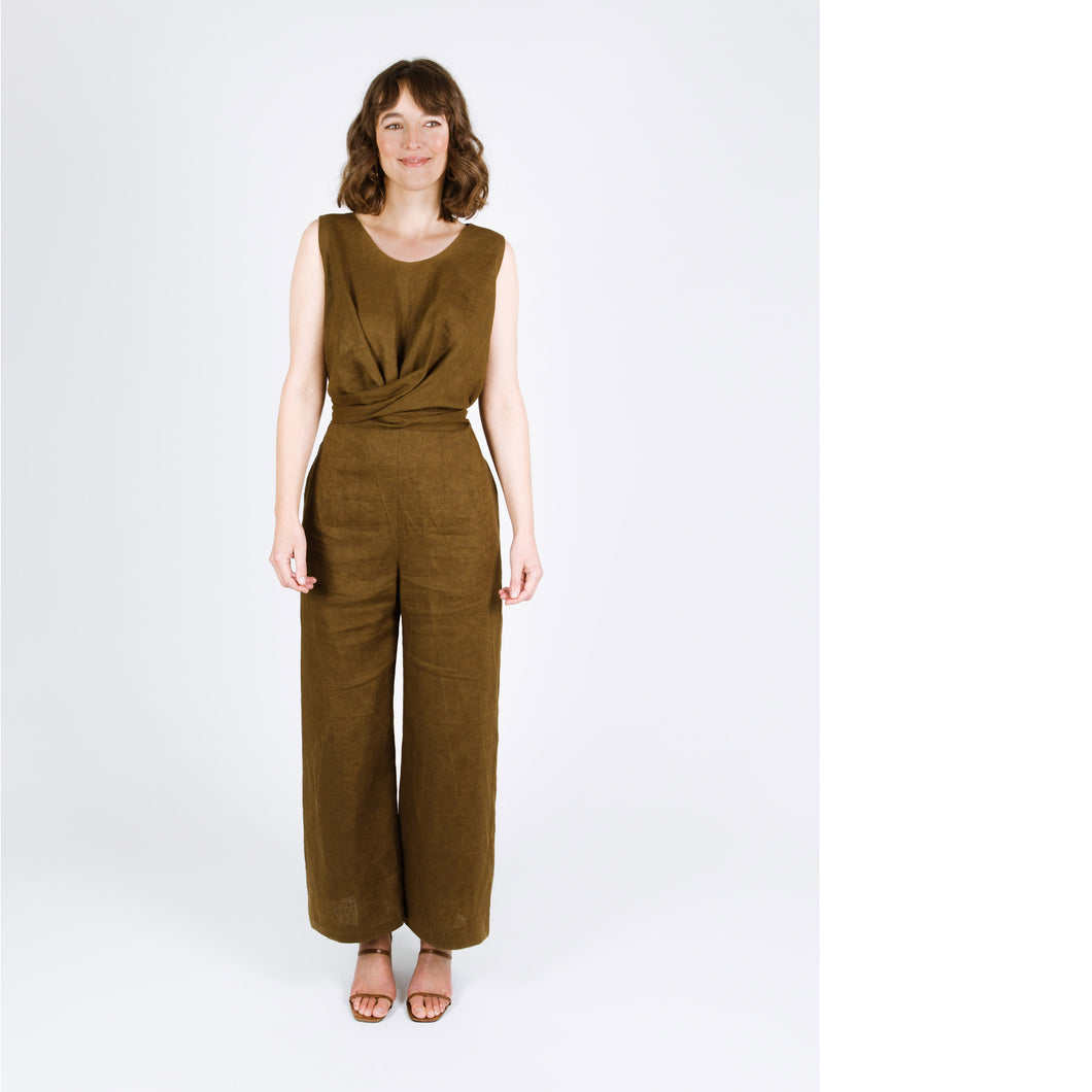 Lady wears a sleeveless full length jumpsuit, with wrap cross over detail at waist
