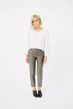 Load image into Gallery viewer, Lady wears a V neck button front Nexus Blouse with long wide sleeves
