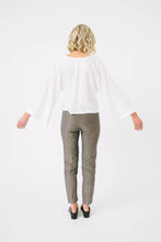 Load image into Gallery viewer, Back of view of lady holding out arms to show wide flare sleeves of Nexus Blouse
