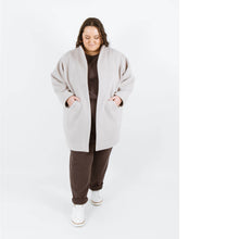 Load image into Gallery viewer, Lady wears Nova coat with hands in slanted front pockets
