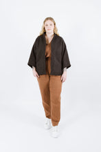 Load image into Gallery viewer, Lady wears a shorter version of the Nova coat with 3/4 length sleeves
