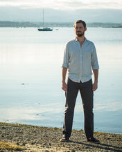 Load image into Gallery viewer, Man stood next to lake wearing Quadra Jeans trousers in a chino fabric.
