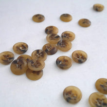 Load image into Gallery viewer, Recycled Paper fibre buttons strewn across surface shows 4-hole buttons with rounded outer ridge. Reverse dome side with raised &#39;Recycled Paper&#39; wording.
