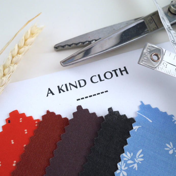 Sample squares of fabric on logo headed paper. Displayed next to pinking shears, and tape measure.