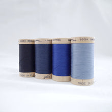 Load image into Gallery viewer, Four wooden reels of Scanfil Organic Cotton Thread in Midnight, Sapphire, Ocean and Dusk colours.
