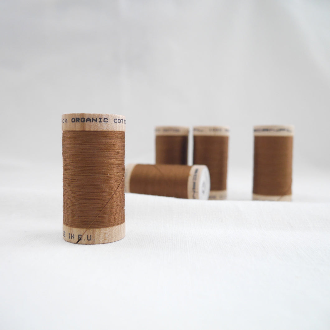 Five wooden reels of Scanfil Organic Cotton Thread in Acorn Brown