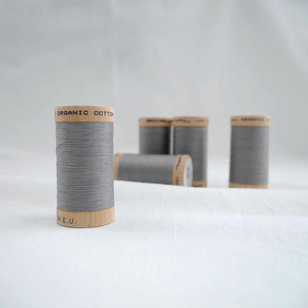 Five wooden reels of Scanfil Organic Cotton Thread in Steel Grey