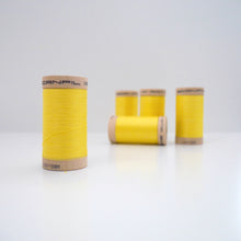Load image into Gallery viewer, Four wooden reels of organic cotton sewing thread on table
