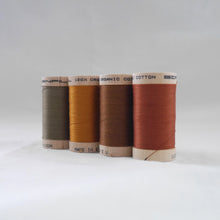 Load image into Gallery viewer, Four wooden reels of organic cotton sewing thread in khaki, gold. acorn brown, and copper colours.
