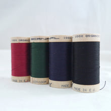 Load image into Gallery viewer, Four wooden reels of organic cotton sewing thread. Wine red, Forest green, Midnight navy, black.
