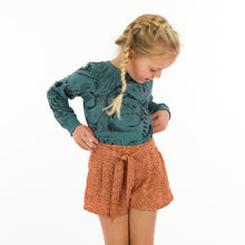 Load image into Gallery viewer, Young girl wears shorts with belt sash made from Flecks fabric
