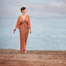 Load image into Gallery viewer, Lady wears a flowy kaftan on beach, made using Flecks fabric
