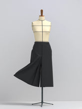Load image into Gallery viewer, Culottes on a mannequin with its right leg raised to show volume
