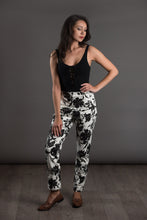 Load image into Gallery viewer, Lady wears a slim leg The City trousers in patterned print, with hand on hip
