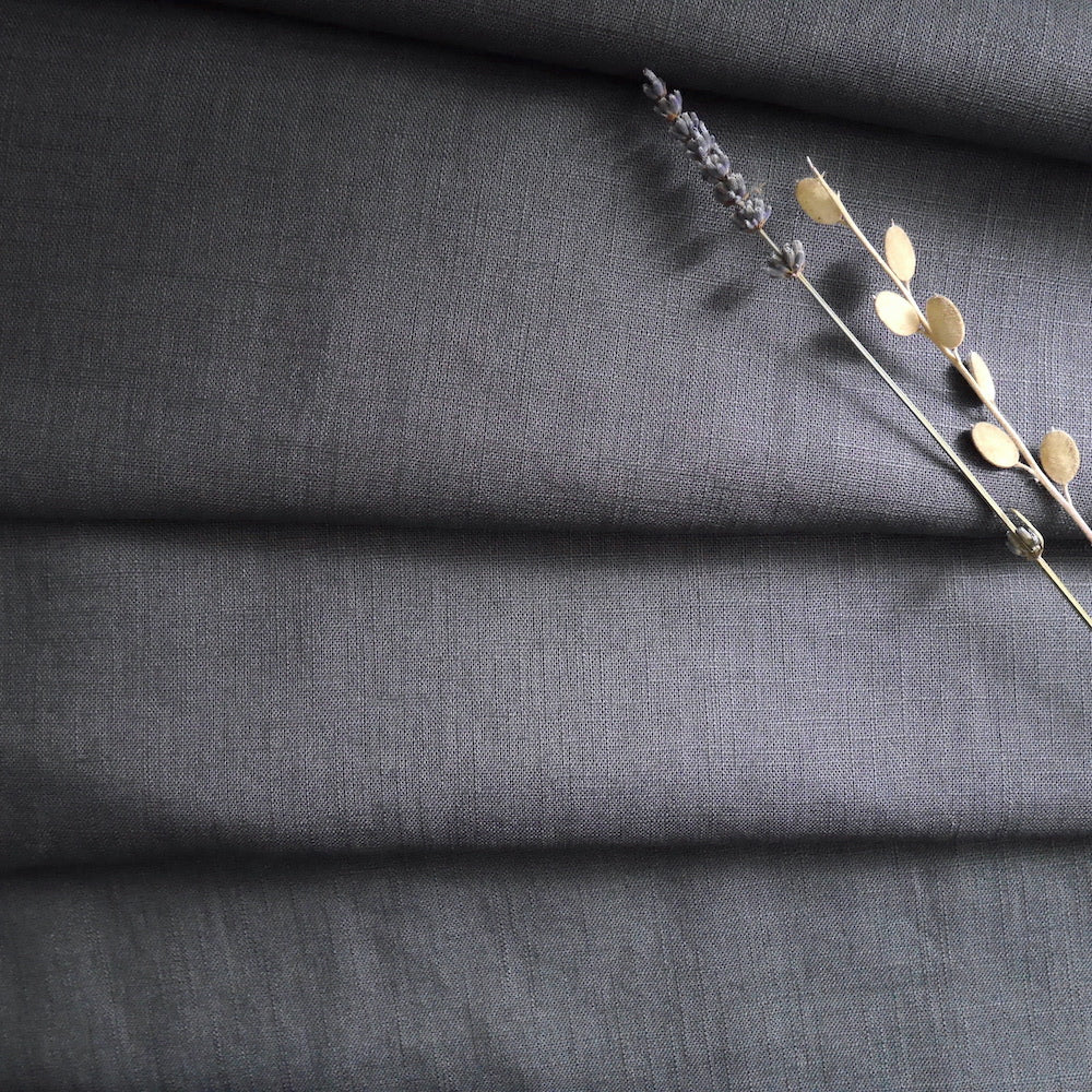 Washed Linen fabric softly folded displayed with dried flower stems