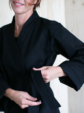 Load image into Gallery viewer, Close up of lady tying belt on Wrap Jacket.
