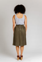 Load image into Gallery viewer, Back view of lady wearing a gathered, knee-length Brumby skirt with exposed metallic zip at centre back waistband.
