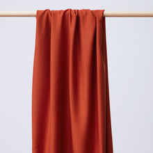 Load image into Gallery viewer, EcoVero Viscose Fabric hangs and drapes over a wooden pole
