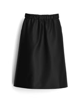 Load image into Gallery viewer, A-Line midi skirt with elasticated waistband lays in front of plain white surface
